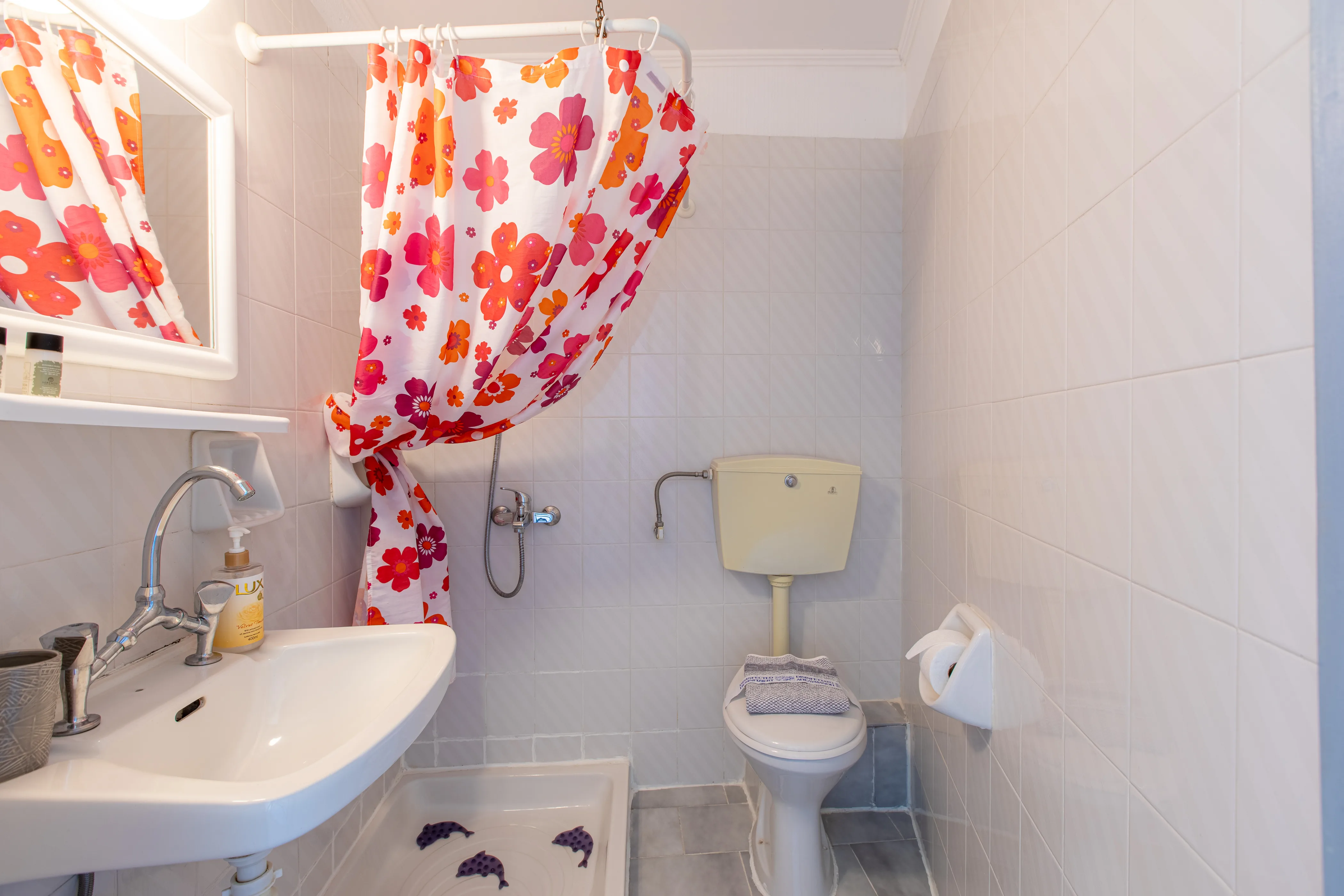 inside view of the bathroom featuring a shower area with a long curtain