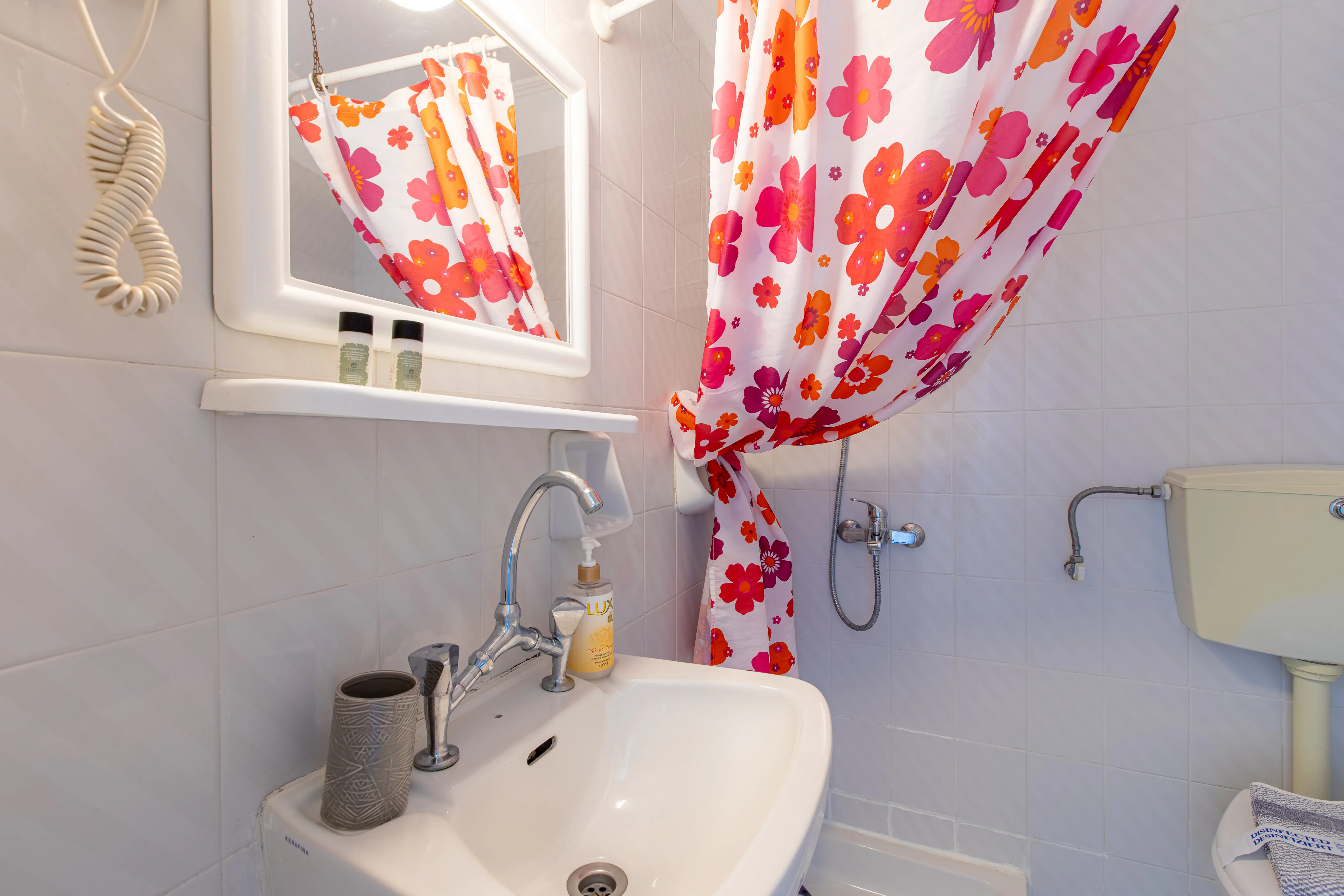 inside view of the bathroom featuring the sink with a mirror above it