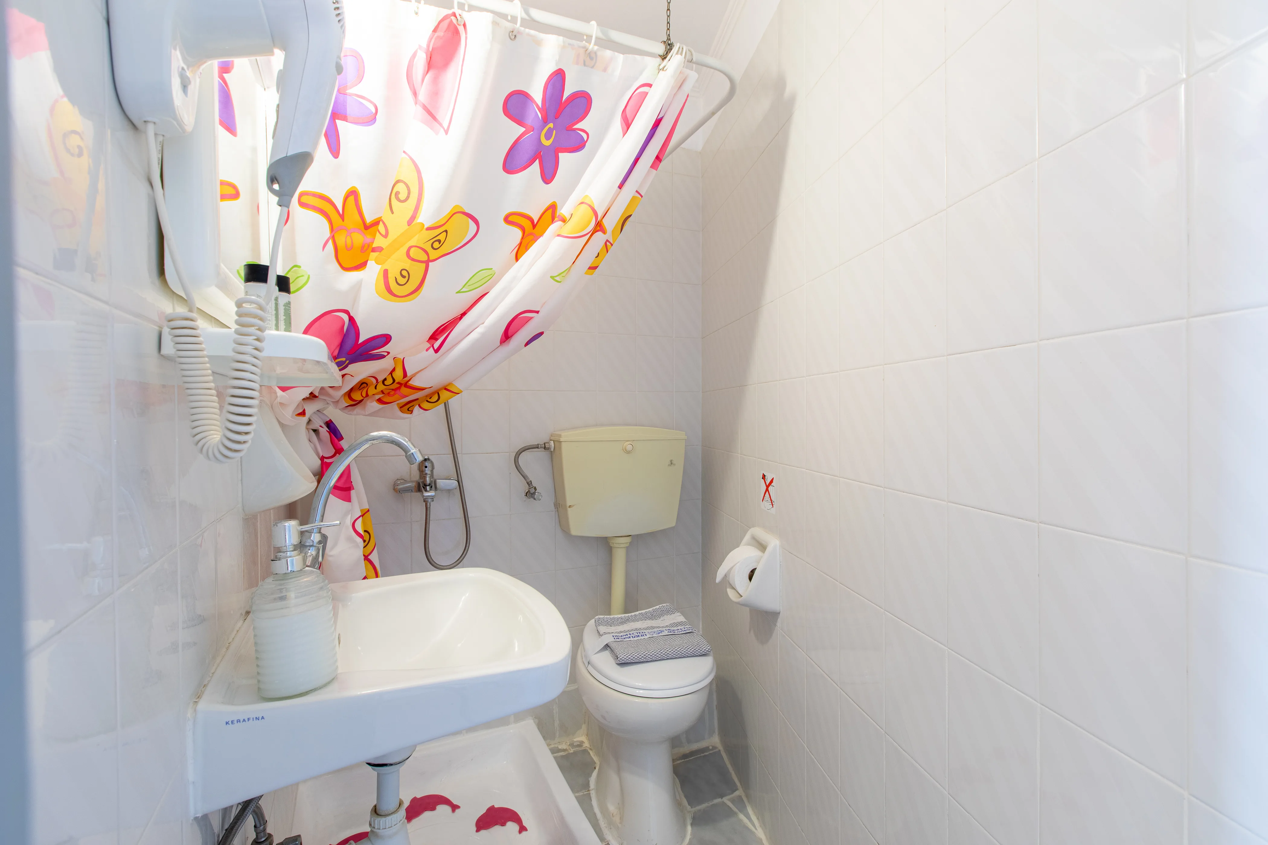 inside view the bathroom with a sink , toilet and a shower area