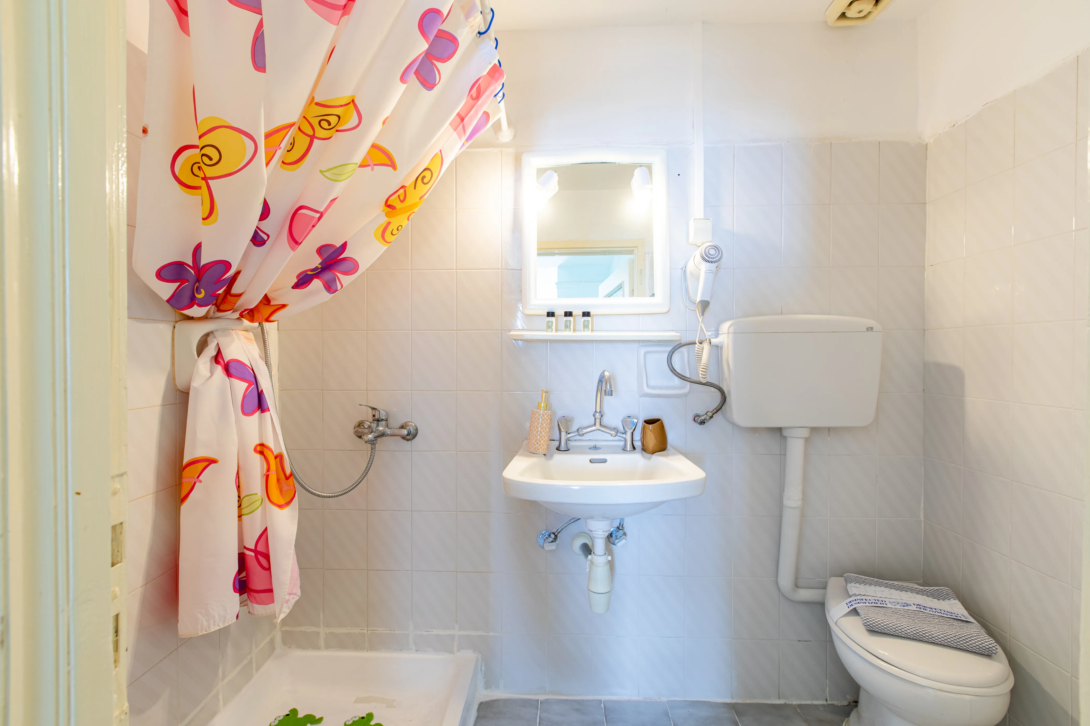inside view of the bathroom with a sink , toilet and shower
