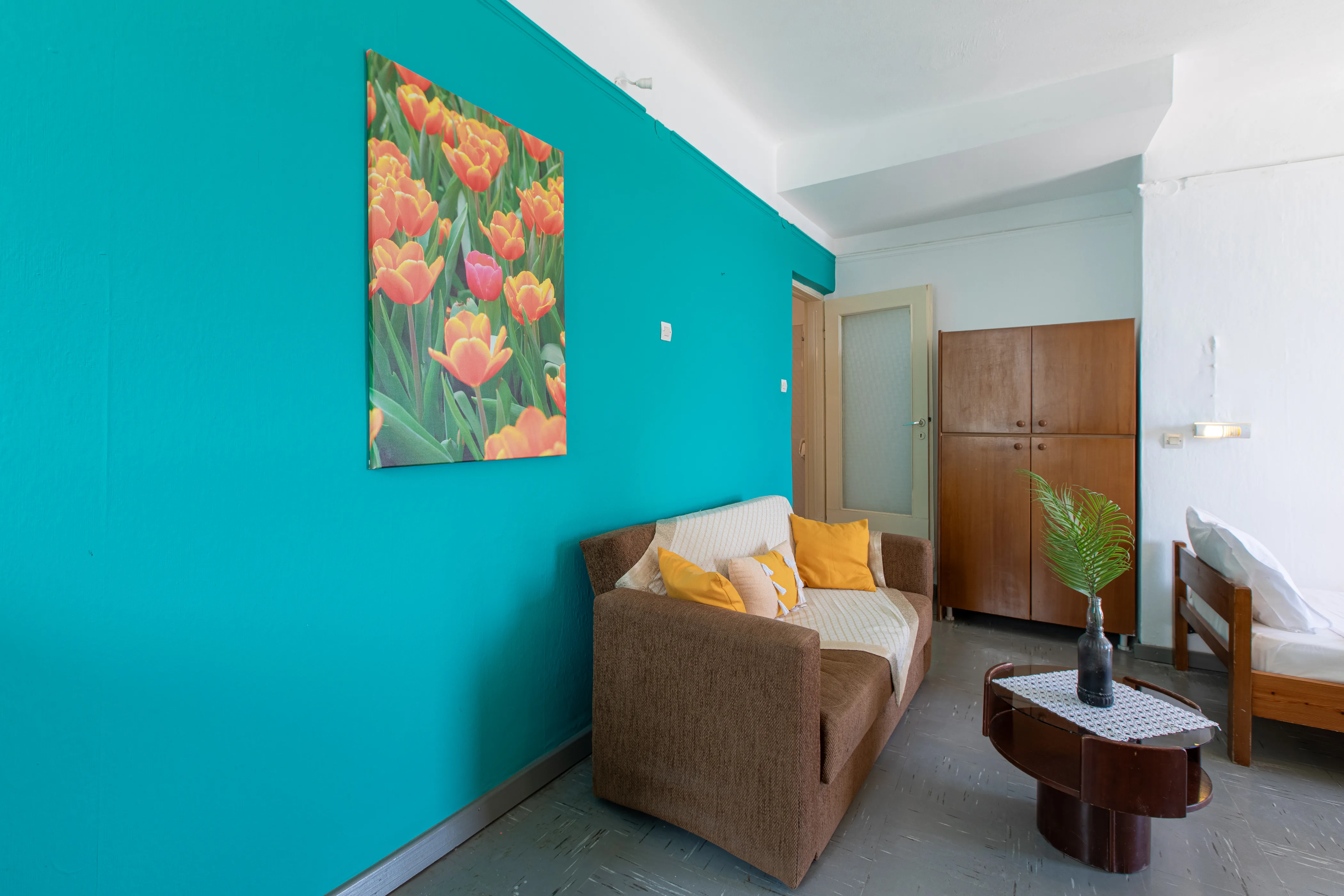 inside view of a room featuring a sofa and a wall painting