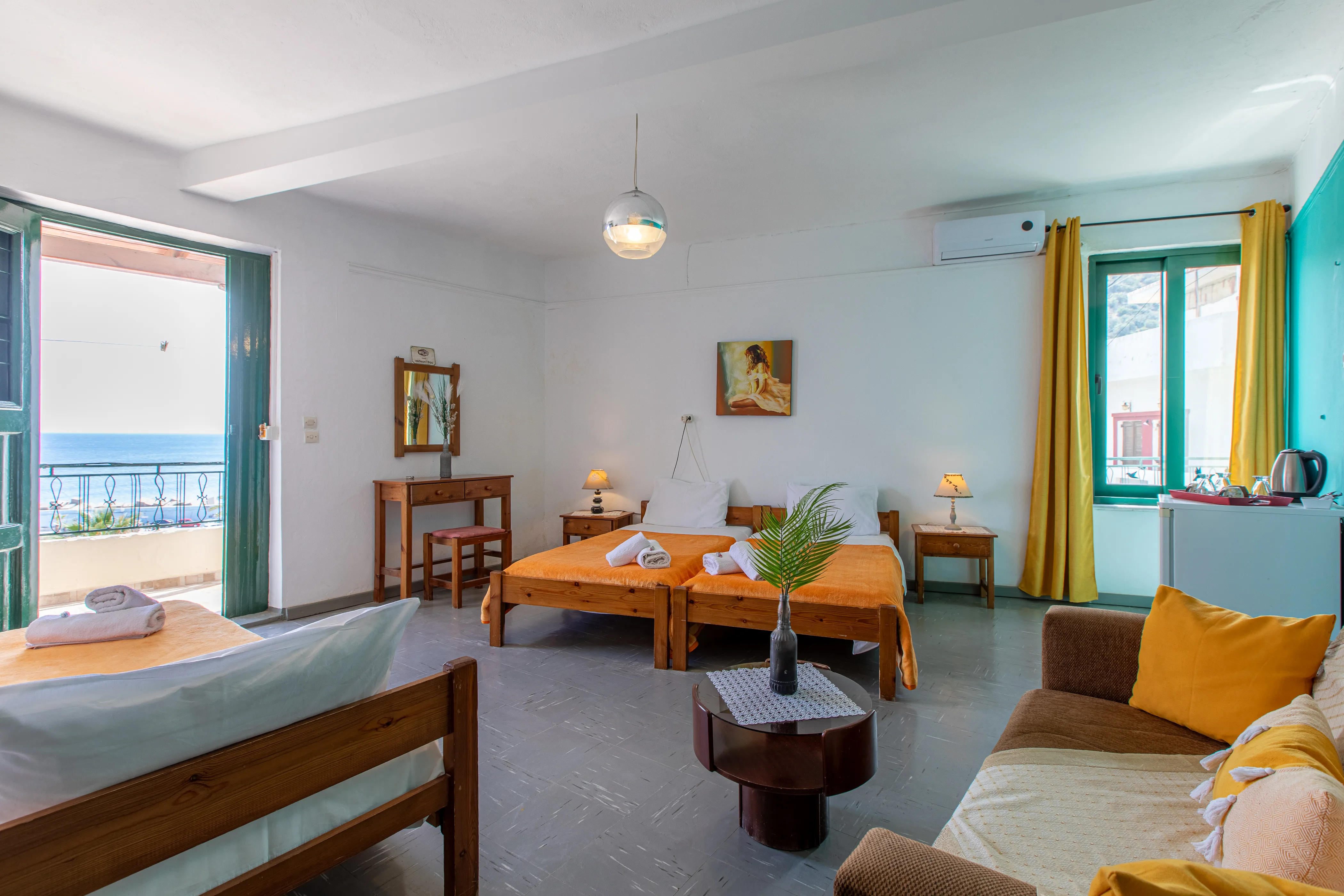 inside view of a room during daylight featuring wooden furniture and an open balcony door